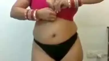 Full-bosomed Indian MILF unbuttons red bra to show her porn pomelos